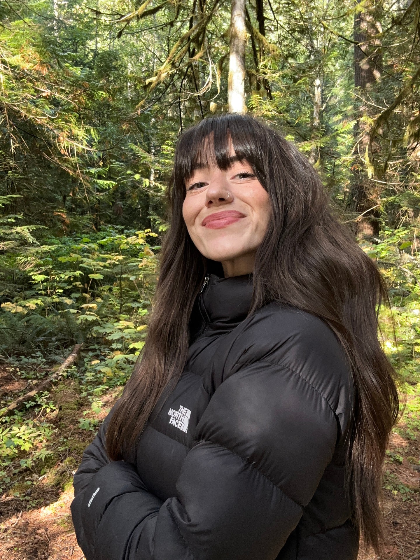 Katee Kanzler standing in a sunlit forest